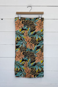 sarong in green and coral palm print on black background