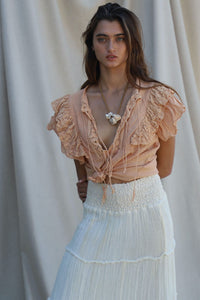 clay colored crop top with ruffle and tie details