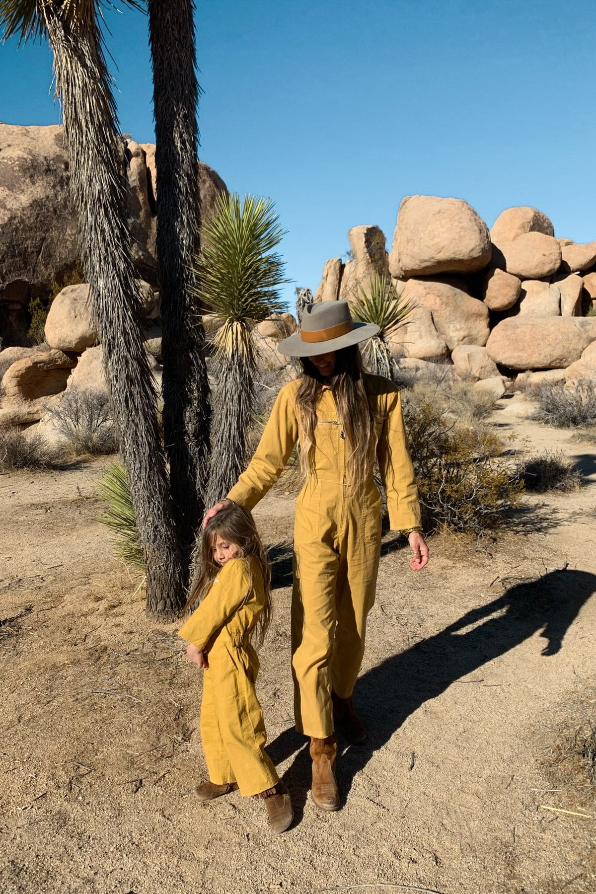 Mom and daughter in matching palmetto station suits in honey gold