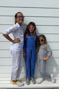 (from left to right) little palmetto station suit in white, palace blue, and stormy stripe