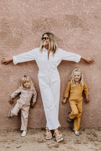 (from left to right) Little Palmetto Station Suit in dusty pink, Palmetto station suit in white, little palmetto station suit in honey gold